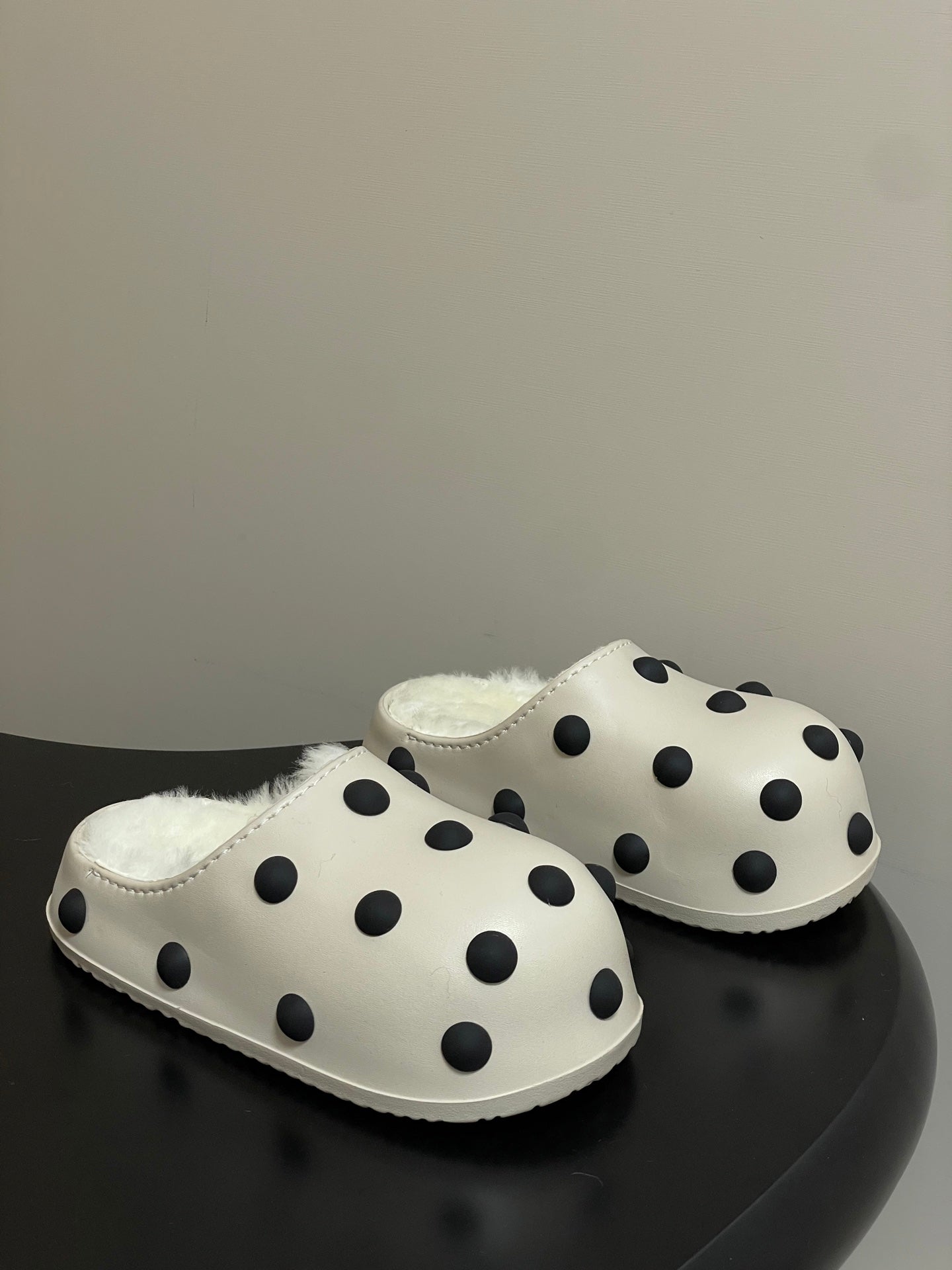 Cream polka-dot slip-on clogs with plush shearling lining and rounded toe