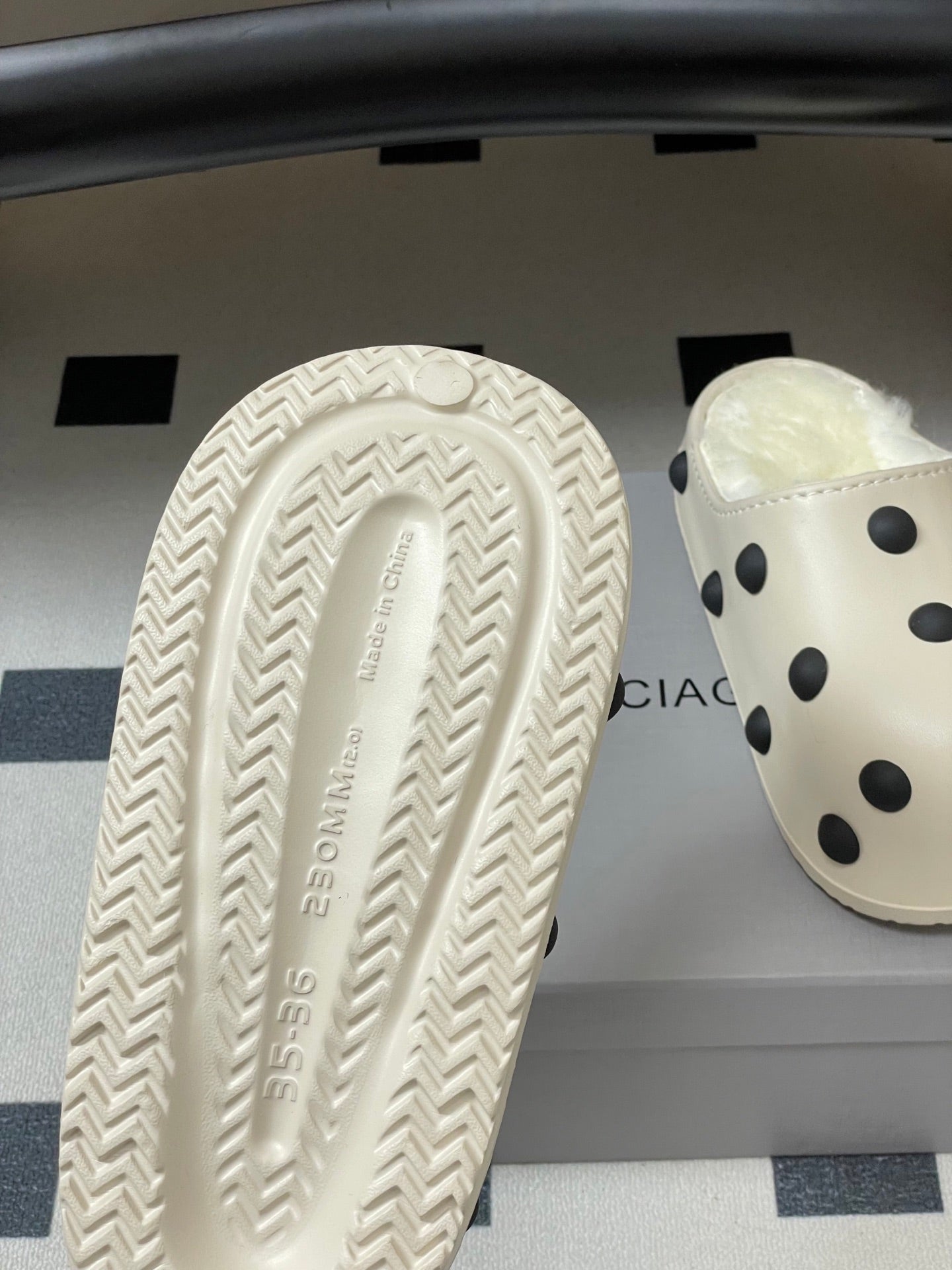 Cream rubber outsole with patterned tread, paired with polka-dot clog