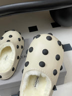 Cream polka-dot clogs with shearling lining and small logo on inner footbed
