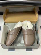 Taupe shearling slide sandals in box with strap and rounded toe