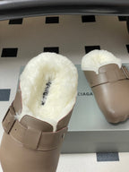 Taupe shearling slide sandals with wide buckle strap, side view