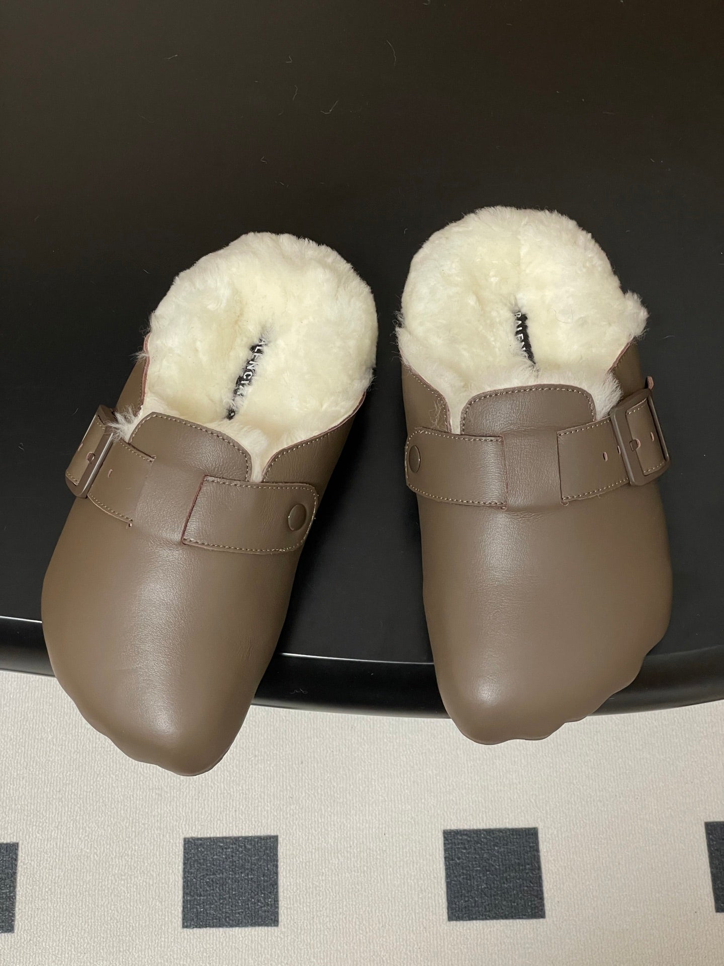 Taupe shearling mule sandals with wide cross strap and metal buckle
