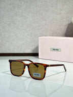 MiuMiu glasses with tortoiseshell frames and dark amber lenses