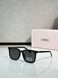 MiuMiu glasses with black rectangular frames and dark gray lenses
