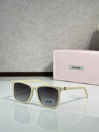 MiuMiu glasses with cream frames and dark lenses