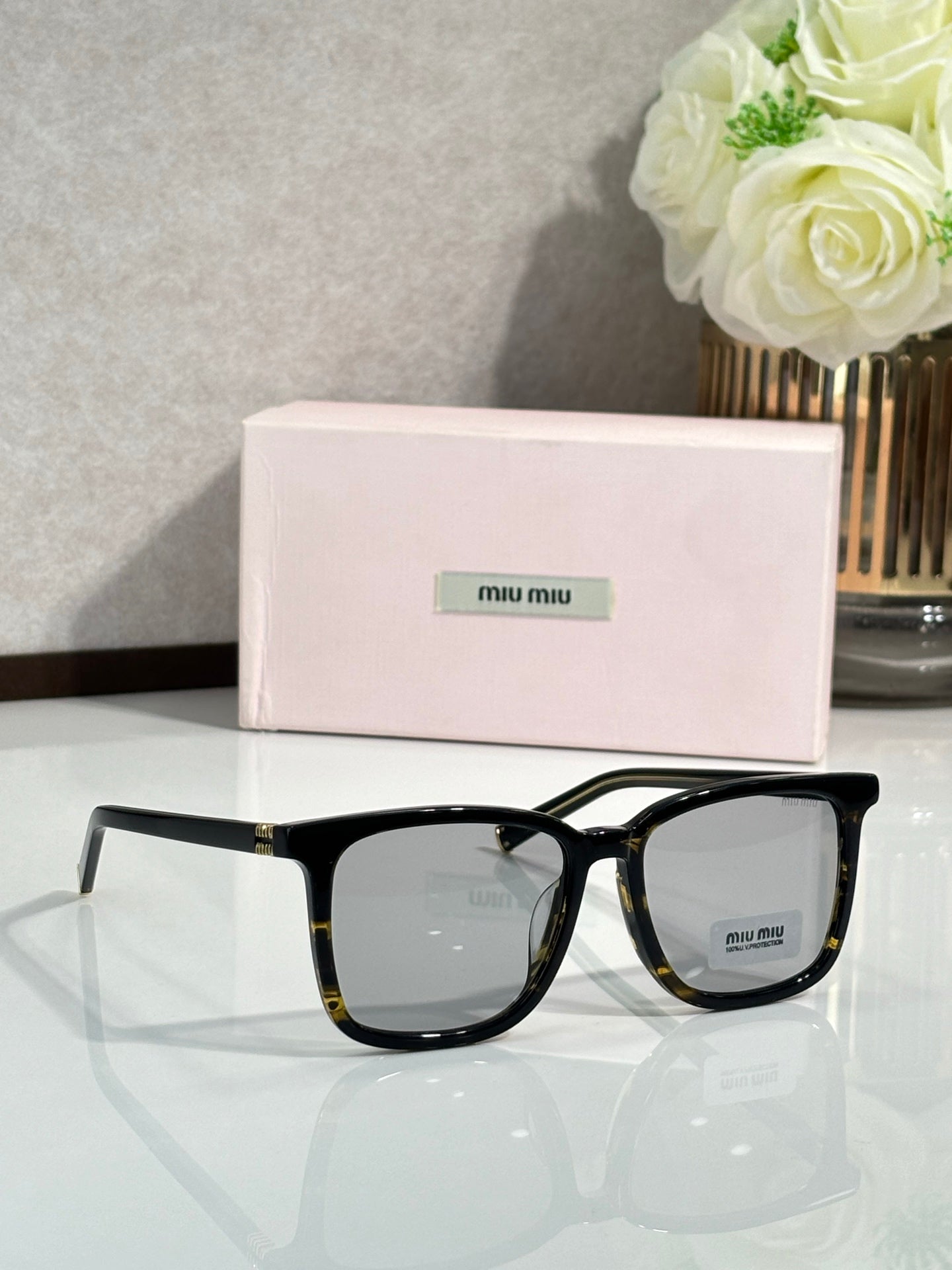 MiuMiu glasses with black frames and gray lenses