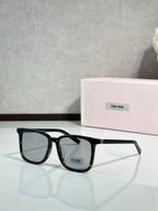 MiuMiu glasses with black frames and clear lenses