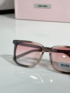 MiuMiu glasses close-up with brown frames and pink tinted lenses