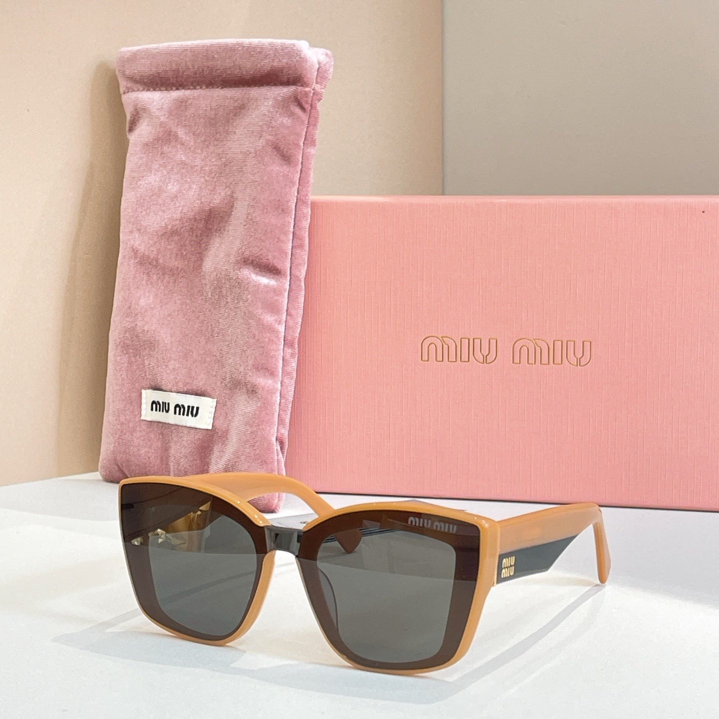 MiuMiu square sunglasses with tortoiseshell frames and dark lenses, in pink pouch