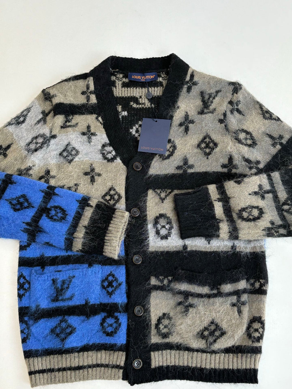 Knit cardigan front, button placket, black & cream with blue stripe motifs