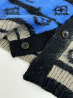 Knit cardigan cuff detail with black buttons, black & cream knit with blue band