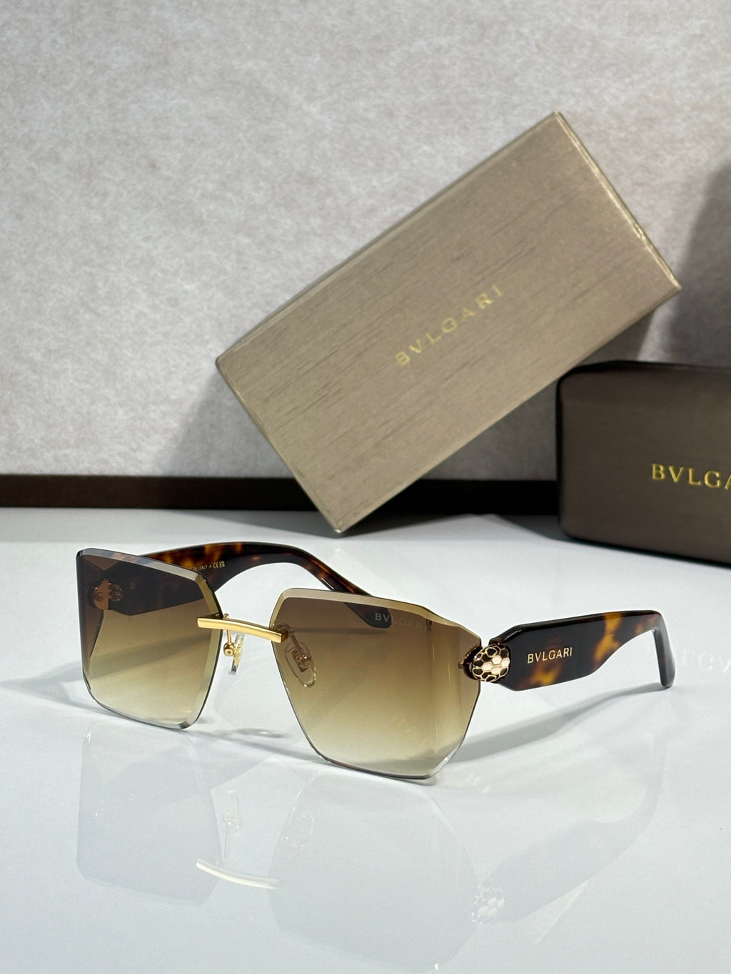 Bvlgari sunglasses with amber gradient lenses and tortoiseshell frame, gold hinge detail
