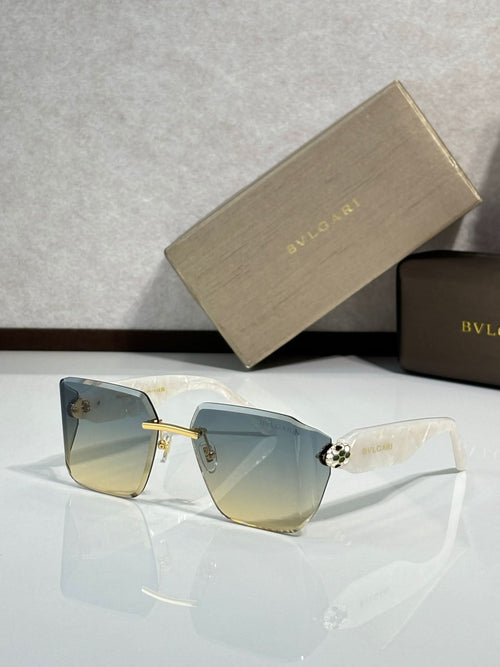 Bvlgari sunglasses with gray-blue gradient lenses and dark frame, gold bridge detail