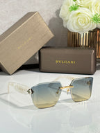 Bvlgari sunglasses with pale gradient lenses and light frame, crystal-like hinge ornaments