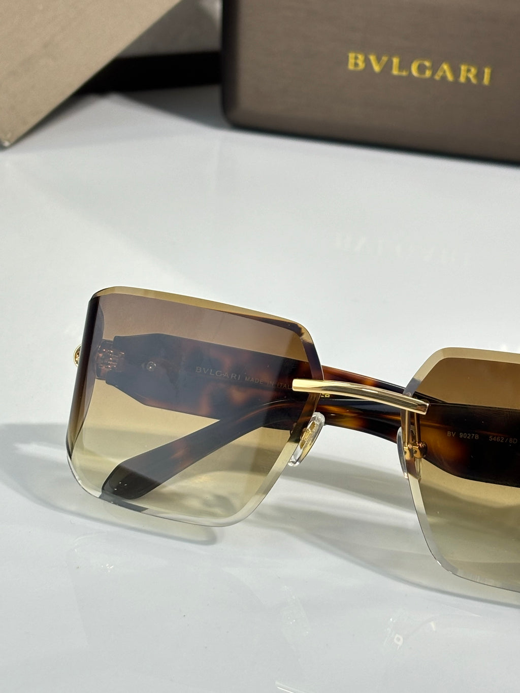 Bvlgari sunglasses with amber gradient shield lenses and tortoiseshell frame, gold bridge