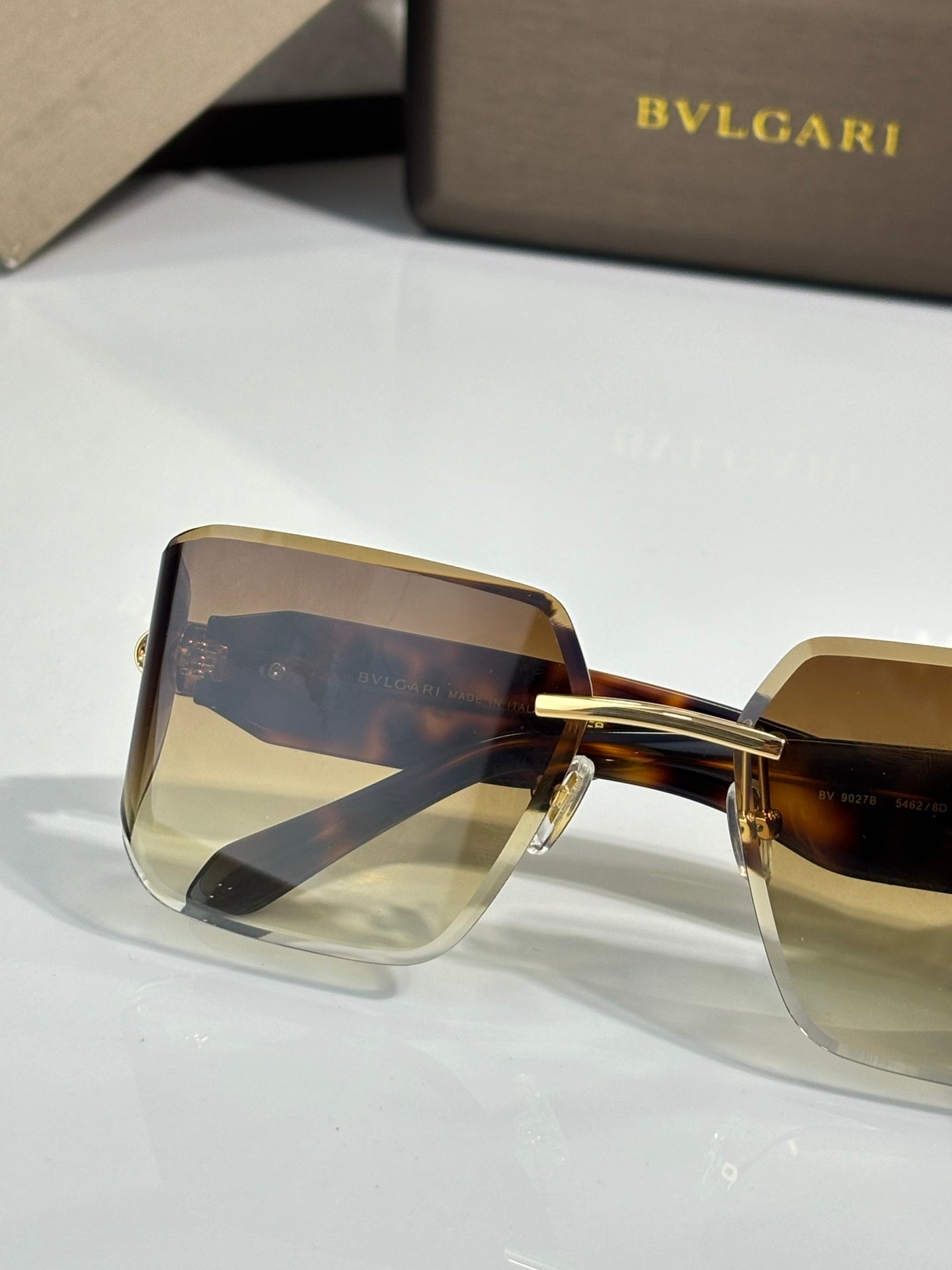 Bvlgari sunglasses with amber gradient shield lenses and tortoiseshell frame, gold bridge