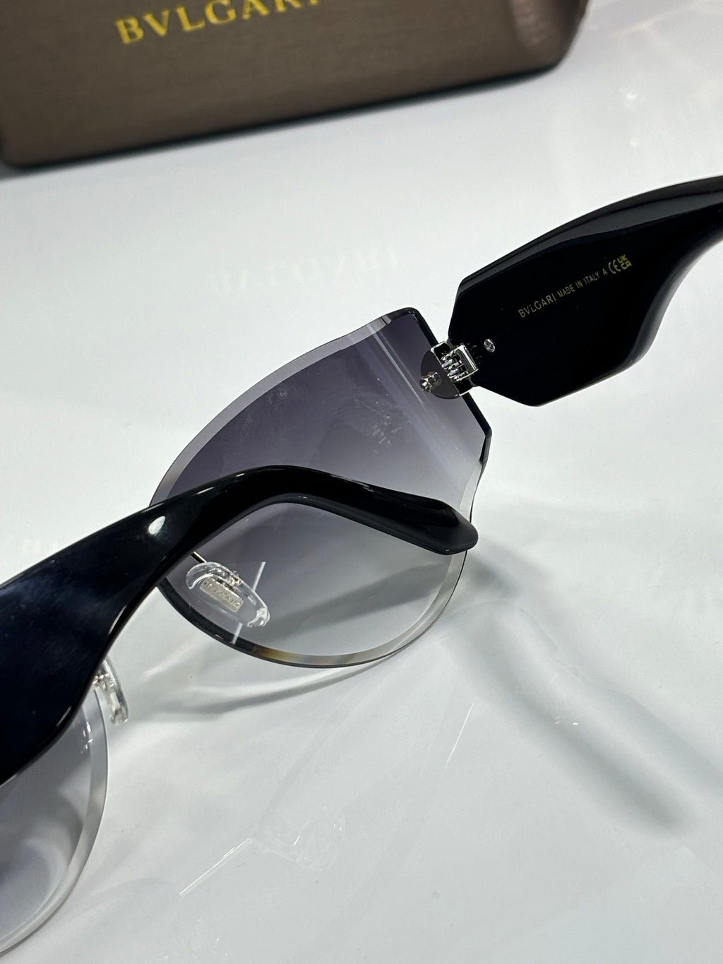 Cat-eye sunglasses by Bvlgari with dark lenses and black frame with gold-tone hinge