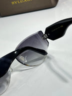 Cat-eye sunglasses by Bvlgari with dark lenses and black frame with gold-tone hinge