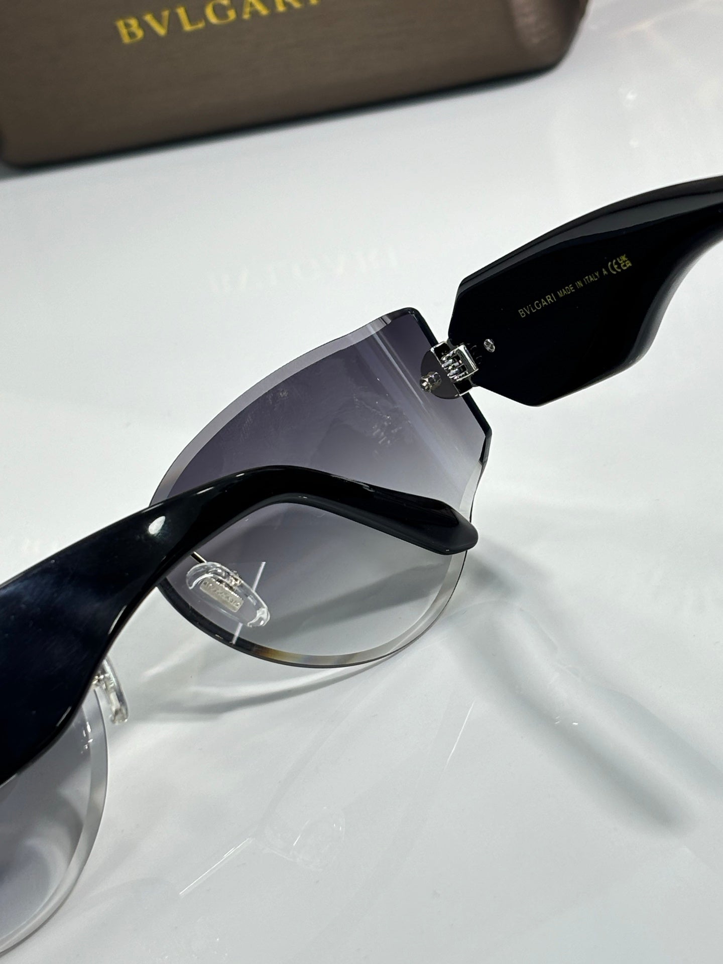 Cat-eye sunglasses by Bvlgari with dark lenses and black frame with gold-tone hinge