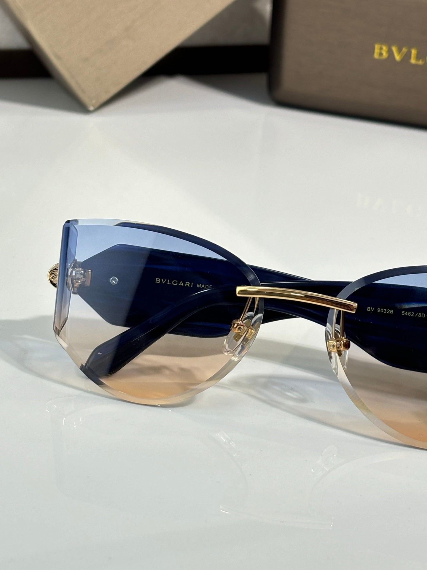 Cat-eye sunglasses by Bvlgari with blue-tinted lenses and blue front frame