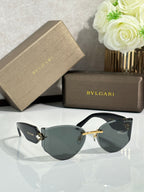 Cat-eye sunglasses by Bvlgari with dark lenses, black frame, and gold-tone details