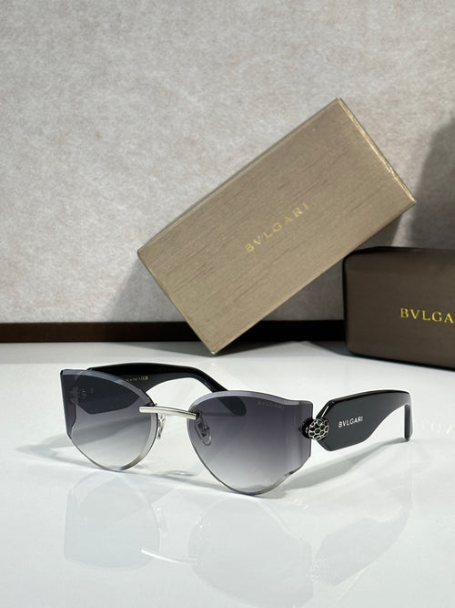 Cat-eye sunglasses by Bvlgari with dark lenses and black frame with gold hardware