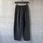 Black wide-leg pants with elastic waistband and centered back seam detail