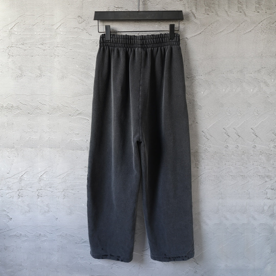 Black wide-leg pants with elastic waistband and centered back seam detail