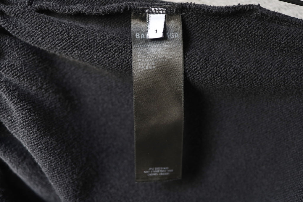 Black fabric inner size label tag on pants waistband area