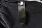 Black fabric inner size label tag on pants waistband area