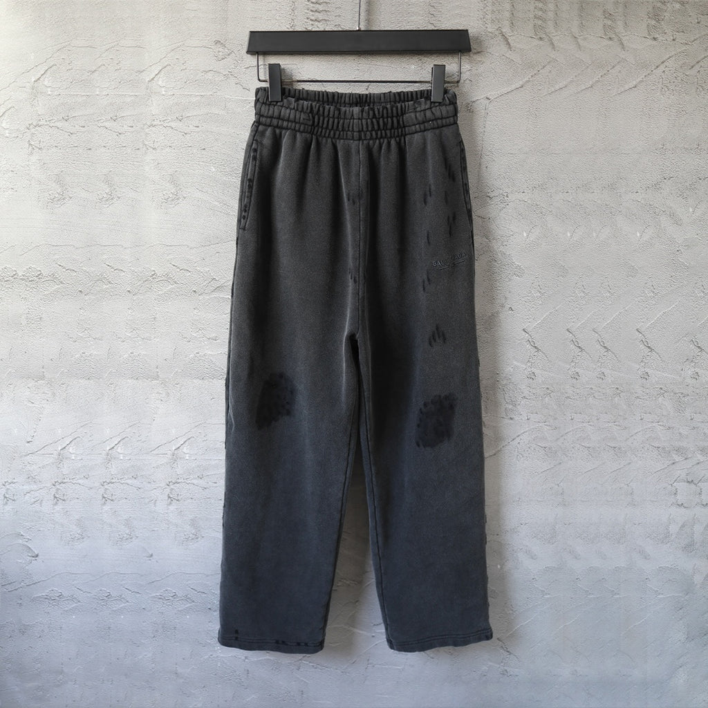 Black drawstring-style pants with elastic waistband and wide straight legs