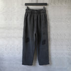 Black drawstring-style pants with elastic waistband and wide straight legs
