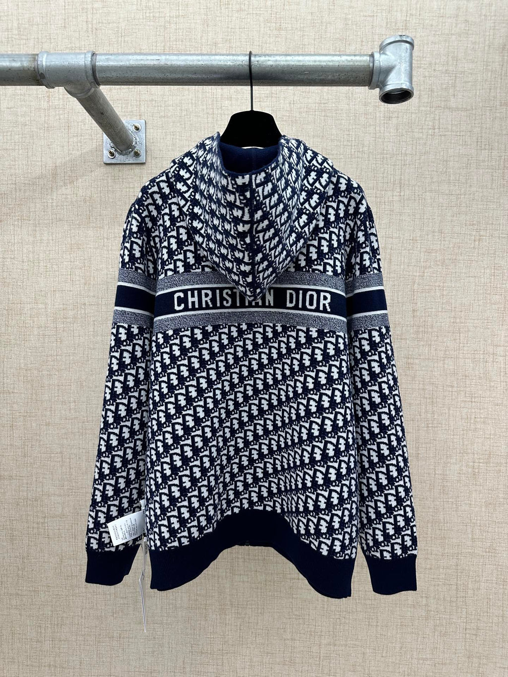 Navy and white patterned zip-up hoodie with “Christian Dior” logo stripe across chest.