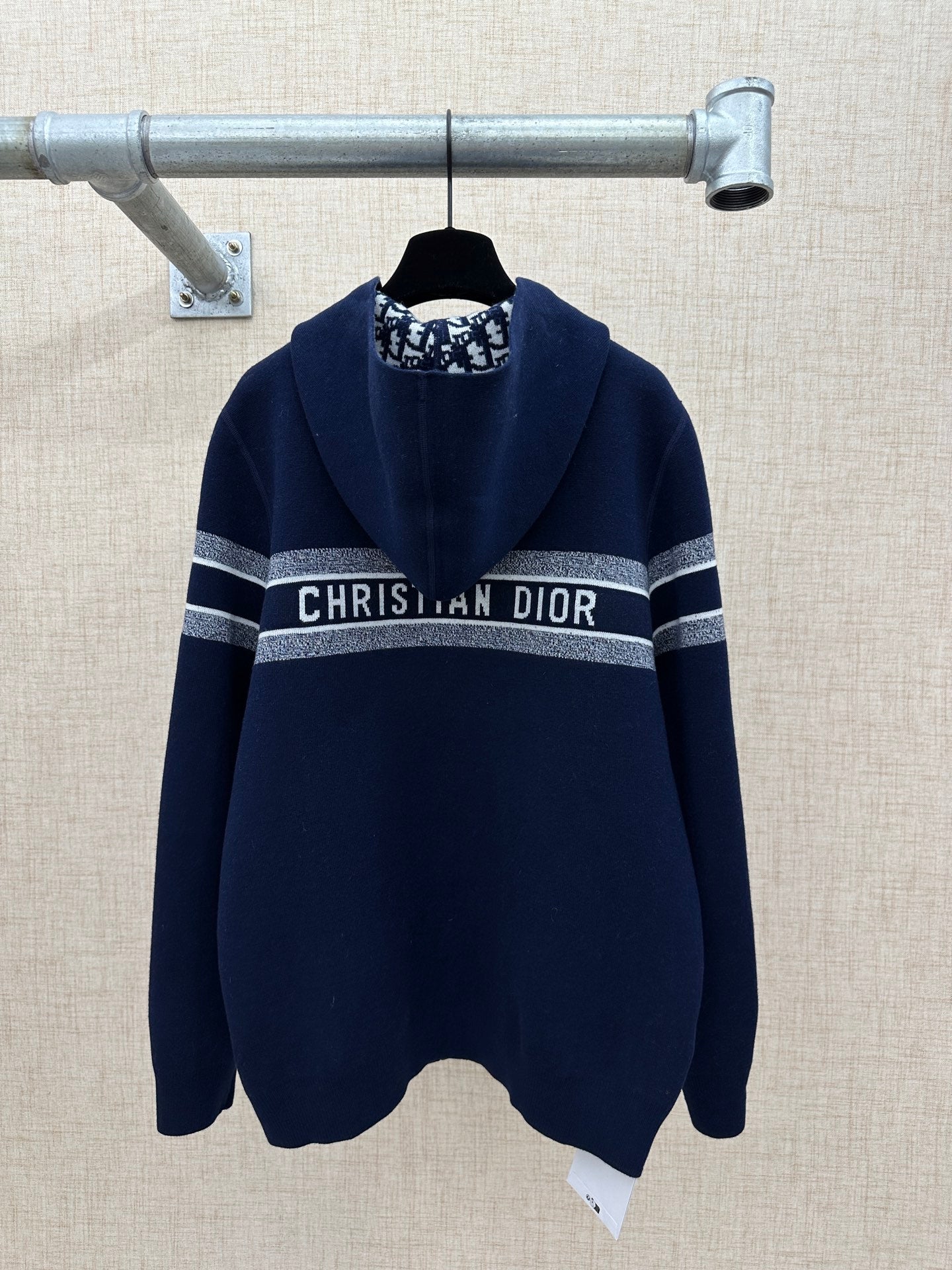 Navy zip-up hoodie with hood and “CHRISTIAN DIOR” stripe band on chest