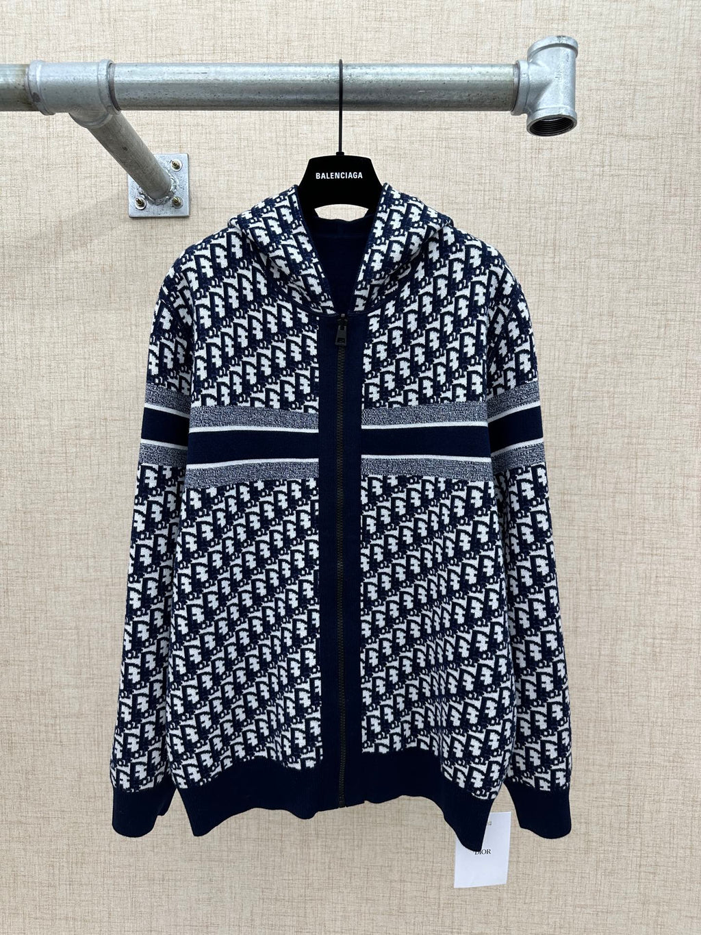 Black and white patterned zip-up hoodie with hood and silver-striped band