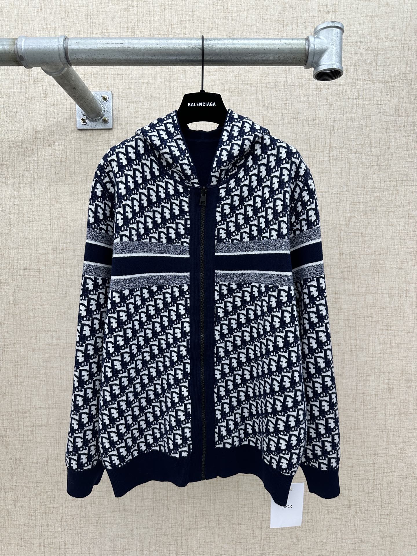 Black and white patterned zip-up hoodie with hood and silver-striped band