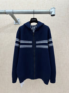 Navy zip-up hoodie with striped bands on sleeves and hem-length body.