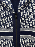 Patterned zip-up hoodie close-up with gold zipper and silver-striped trim