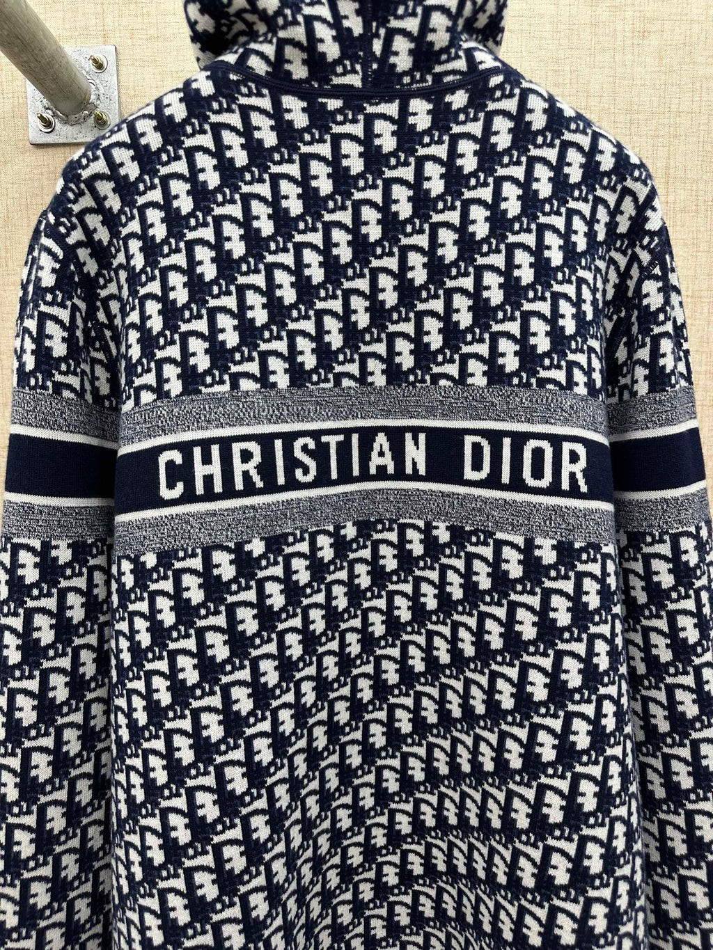 Black and white patterned zip-up hoodie with hood and “CHRISTIAN DIOR” chest stripe
