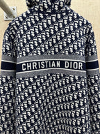Black and white patterned zip-up hoodie with hood and “CHRISTIAN DIOR” chest stripe
