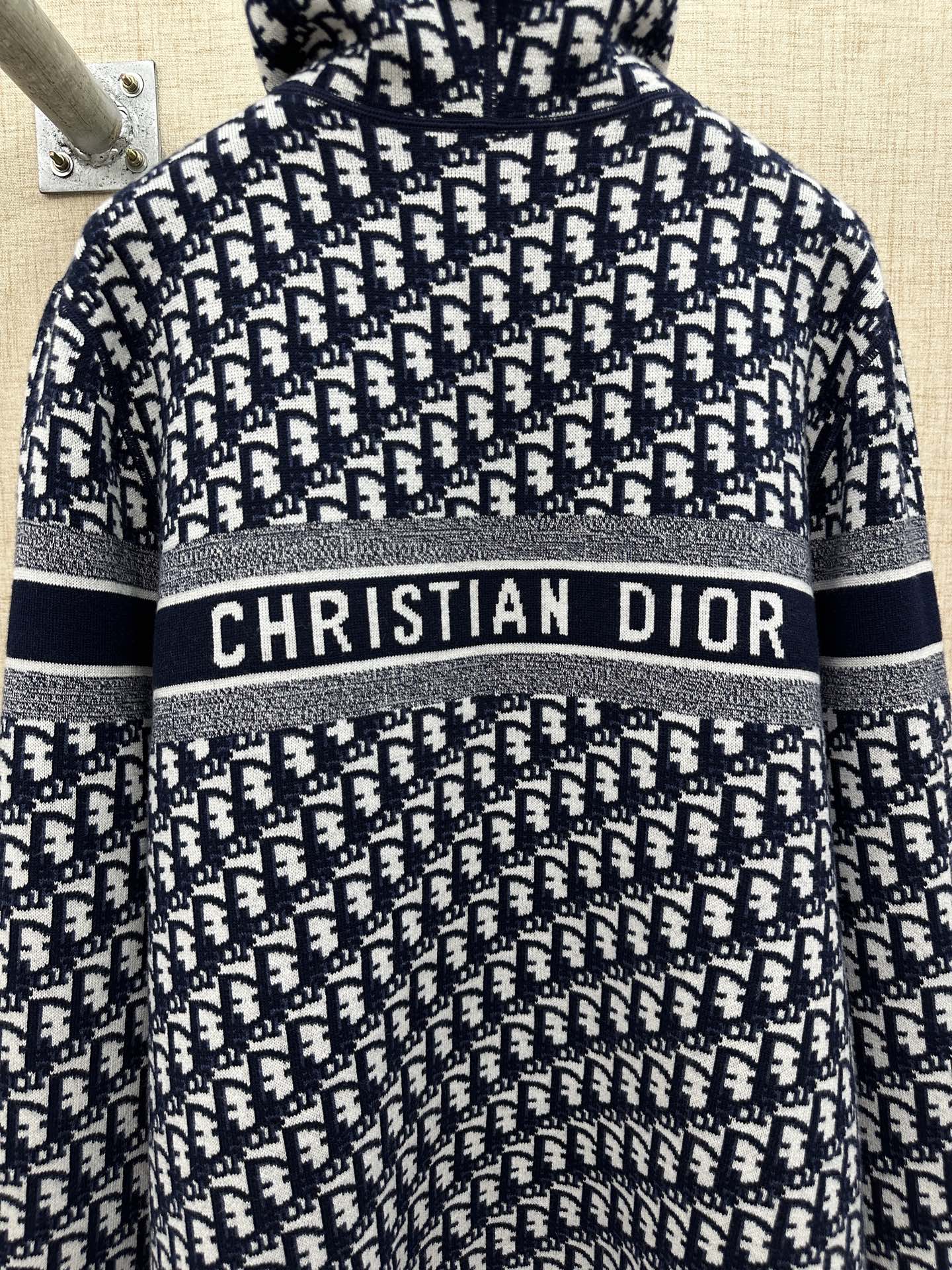 Black and white patterned zip-up hoodie with hood and “CHRISTIAN DIOR” chest stripe