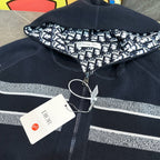 Navy zip hoodie with ribbed collar, silver logo stripe, and Dior price tag