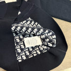 Navy knit hoodie cuff with patterned Dior logo patch and white fabric label