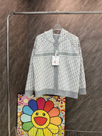 White hooded zip sweatshirt with allover monogram pattern and gray stripe hem.