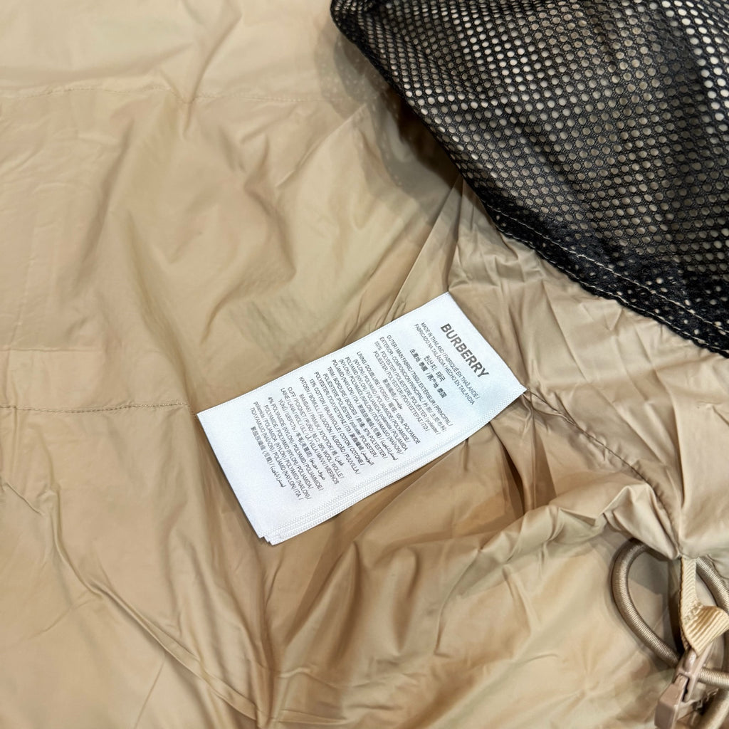 Light beige long coat with drawstring hood and inner care label