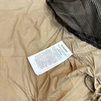Light beige long coat with drawstring hood and inner care label