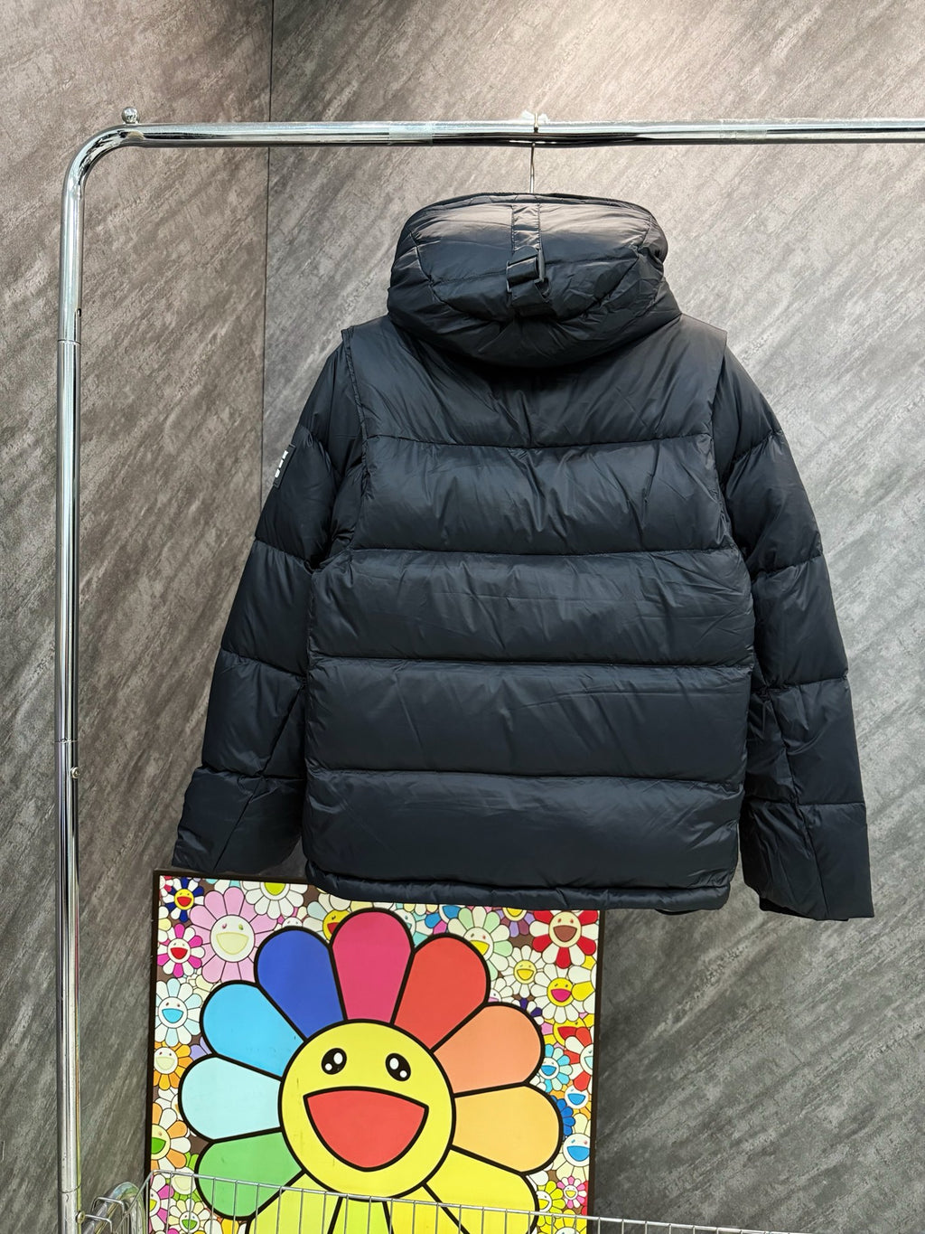 Burberry hooded puffer jacket, dark quilted design with rounded hood and cuffs.