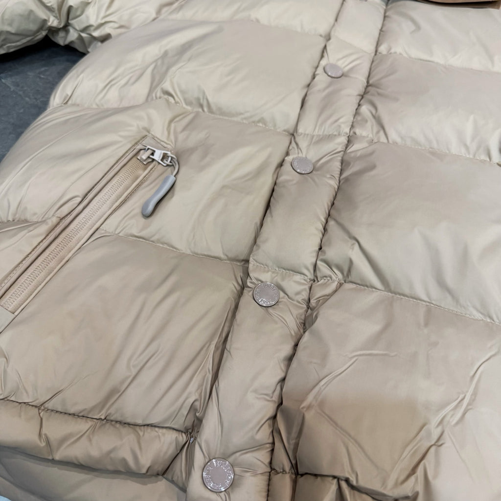 Burberry puffer jacket, light beige quilted panels with snap buttons at seams.