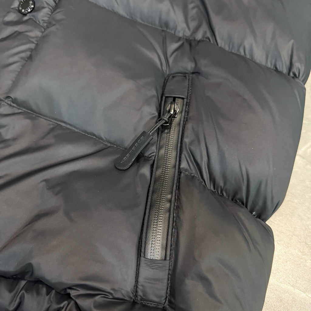 Dark puffer jacket with center zip and stitched quilted panels