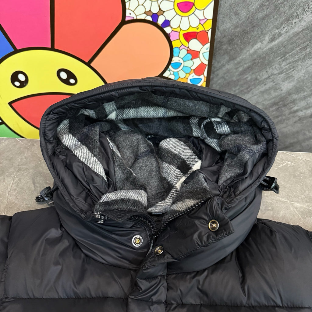 Dark puffer jacket with button placket and checkered hood lining